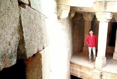 Woman standing by wall