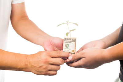 Midsection of man holding hands over white background