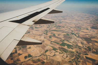 Cropped image of airplane flying over landscape