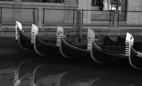 Boats moored on wall in city