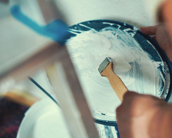 Cropped hands of painter mixing paint