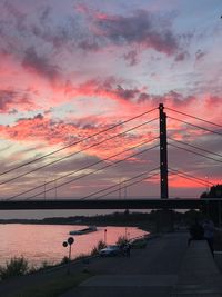 Silhouette bridge against sky during sunset