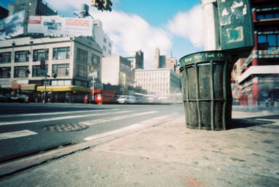 City street and buildings against sky