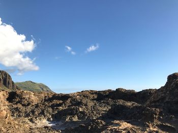 Scenic view of mountains against blue sky