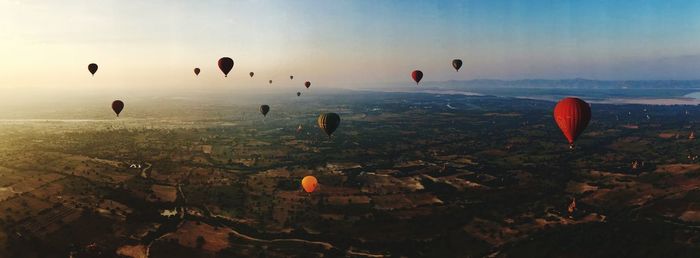 Hot air balloons flying over city