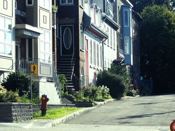 Man walking on road along buildings