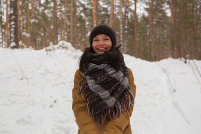 Young woman standing on snow covered land