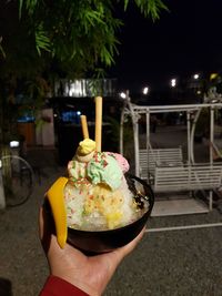 Close-up of hand holding ice cream