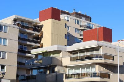 Low angle view of buildings against clear blue sky