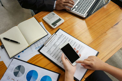 High angle view of man using laptop on table