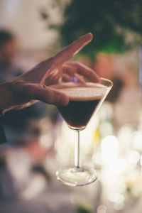 Close-up of hand holding wineglass