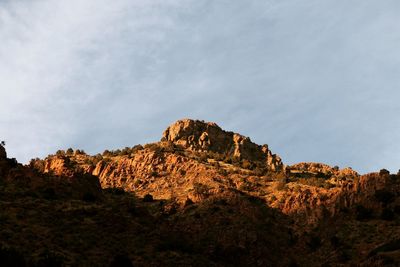 Rock formation on cliff against sky