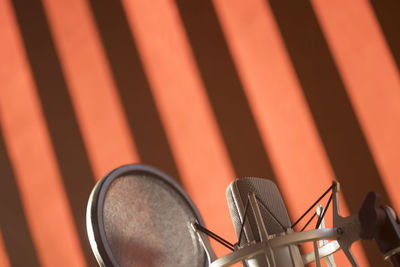 Close-up of microphone against wall