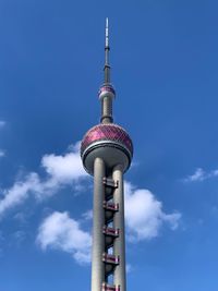 Low angle view of communications tower against sky