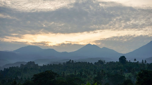 Scenic view of mountains against sky at sunset