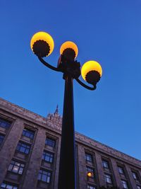 Low angle view of street light against building