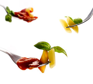 Close-up of chili peppers on white background