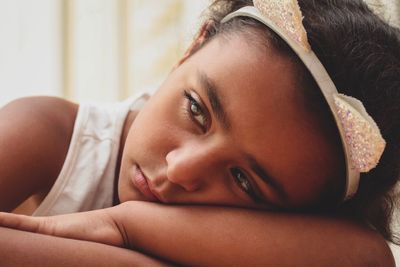 Close-up of sad thoughtful girl looking away at home