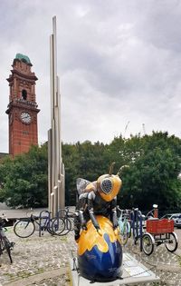 Horse cart in city against sky