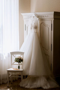 Wedding dress hanging on closet