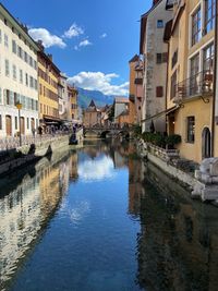 European canal in and old-fashioned french town near the alps