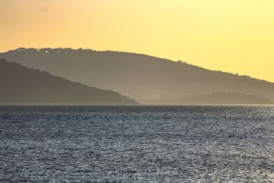 Scenic view of sea against clear sky during sunset
