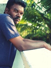 Portrait of young man sitting outdoors