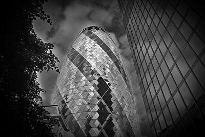 Low angle view of modern building against cloudy sky