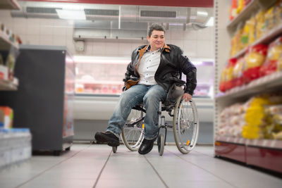 A disabled person in a wheelchair buys groceries