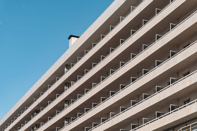 Low angle view of modern building against clear blue sky