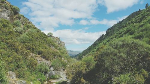 Scenic view of mountains against cloudy sky