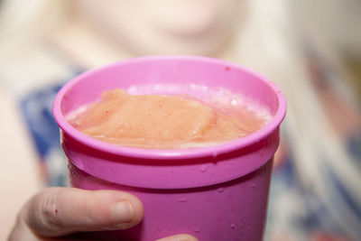 Close-up of hand holding ice cream