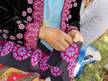 High angle view of woman weaving fabric