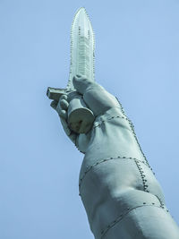 Low angle view of statue against clear blue sky