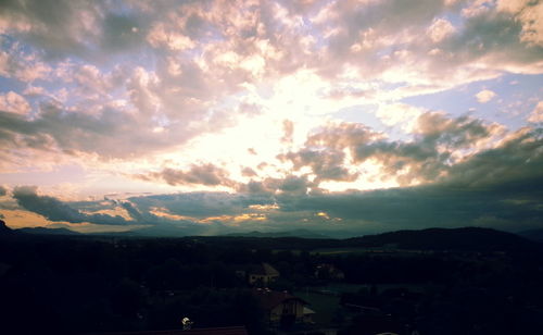 Aerial view of cityscape against dramatic sky