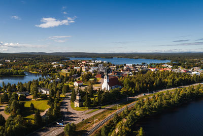 High angle view of townscape by river against sky