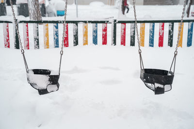 High angle view of swing hanging on snow covered field