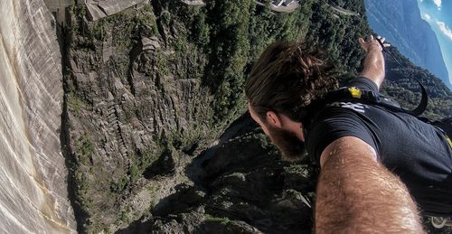 Man bungee jumping over rock formations