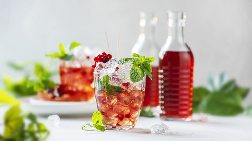 Close-up of freshly made pomegranate juice with ice cubes and mint leaves