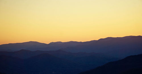 Scenic view of silhouette mountains against clear sky