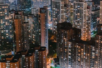 High angle view of illuminated buildings in city at night