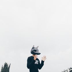 Low angle view of woman standing against wall