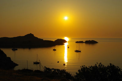 Scenic view of sea against orange sky