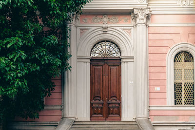 Ornate door on a pink wall