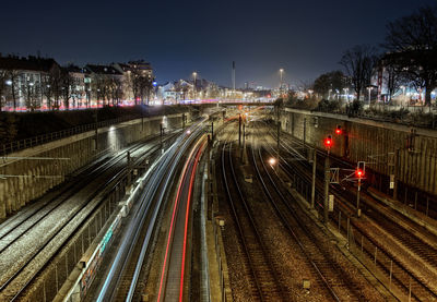 High angle view of light trails on railroad tracks at night