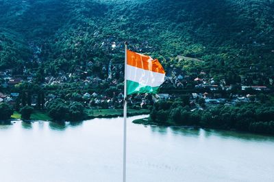 Scenic view of flag against trees