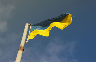 Low angle view of flag against sky