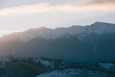 Scenic view of snowcapped mountains against sky