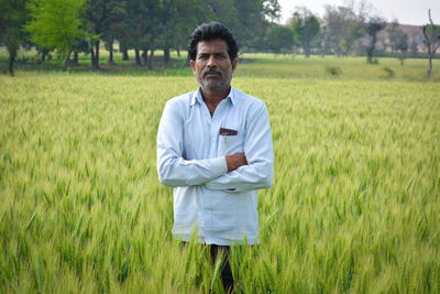 Portrait of man standing in field