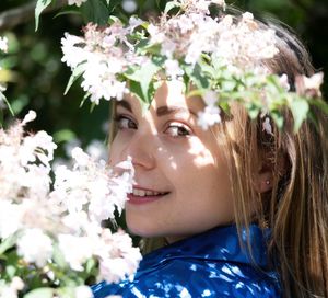 Close-up of young woman with flowers